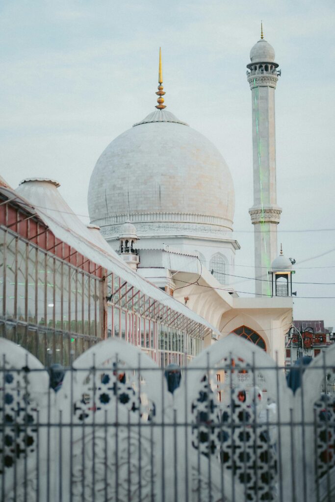 Stunning view of the Hazratbal Shrine with intricate architecture during a soft sunrise.